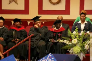 A group of people sitting at a graduation ceremony.