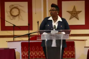 A woman standing at a podium at a church.