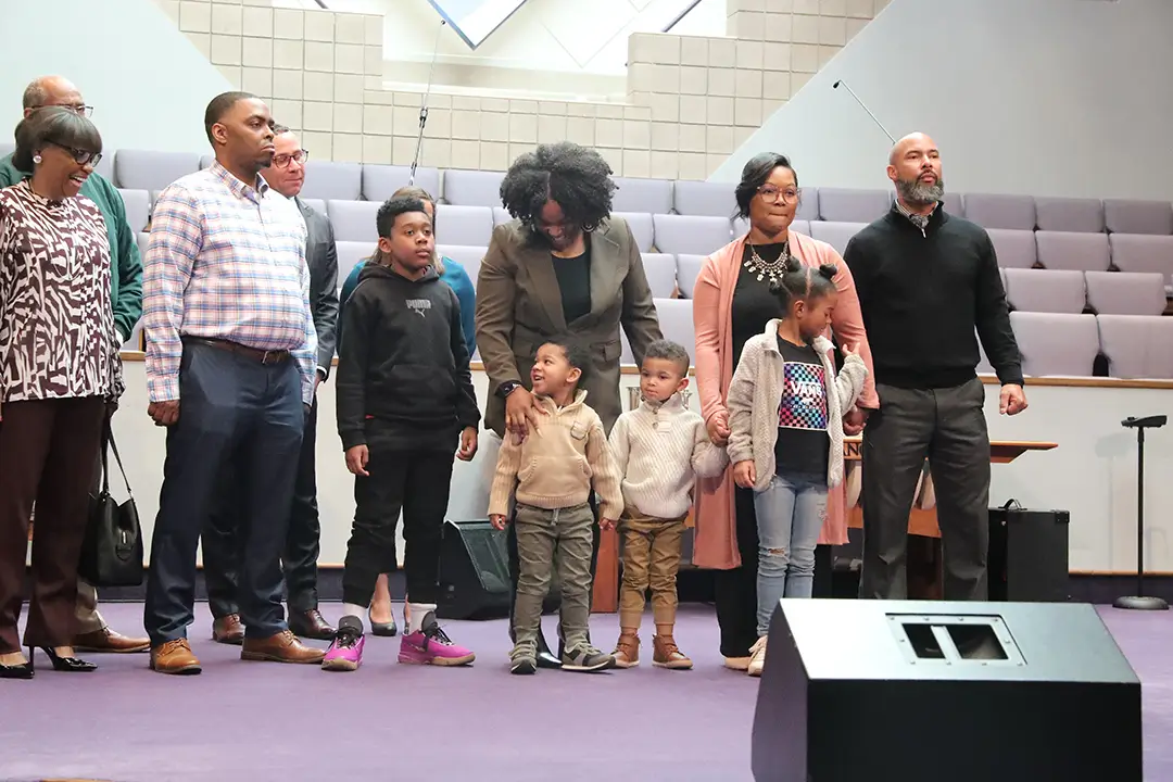 A group of people standing in front of a microphone.